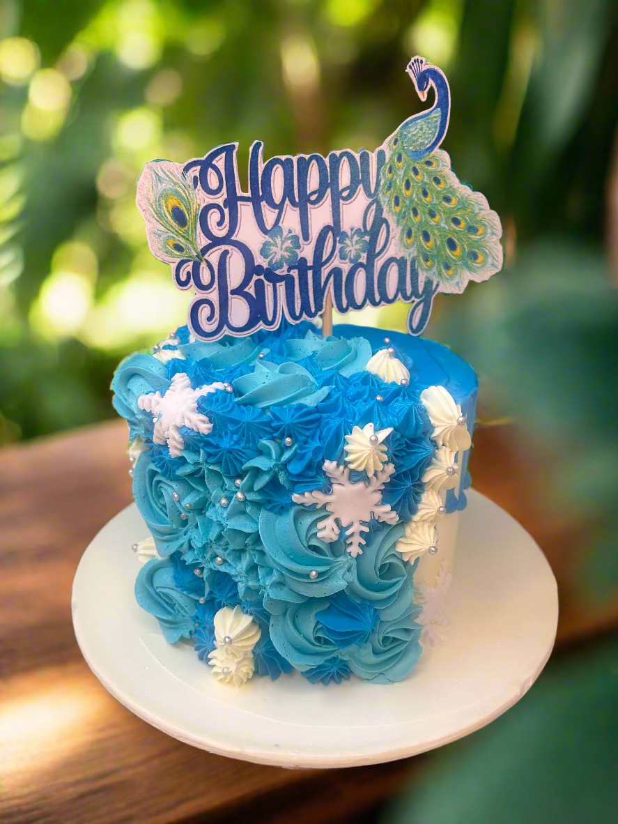 Peacock-Themed Blue Swirl Birthday Cake with Snowflake Decorations | Doon Memories